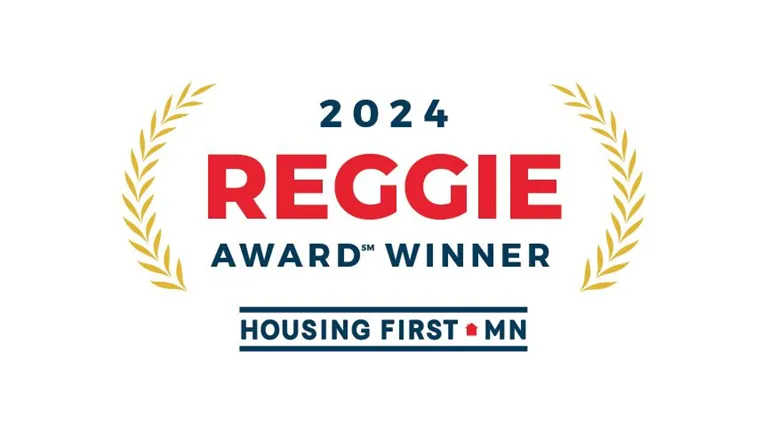 Badge reading '2024 Reggie Award Winner Housing First MN'.