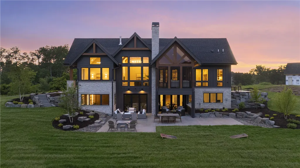 Aerial view of a suburban bungalow at twilight with a spacious yard.