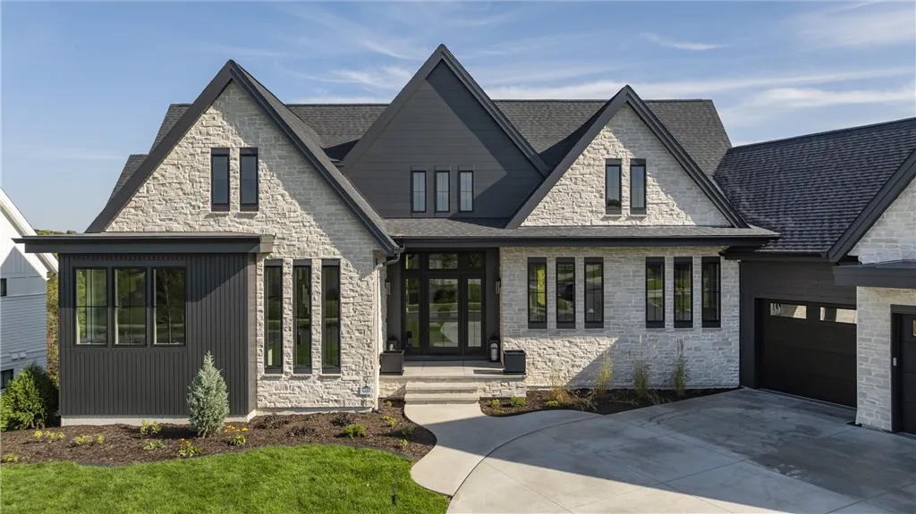 Elegant suburban home with a spacious driveway and upscale architecture.