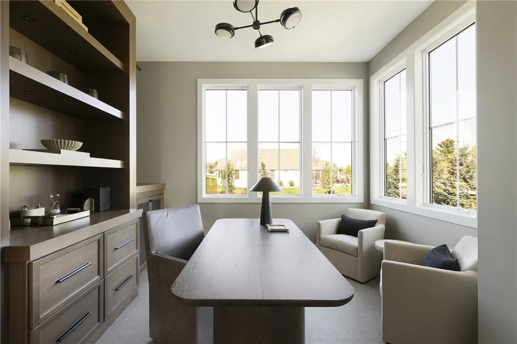 Contemporary minimalist dining room with modern furniture and large windows.