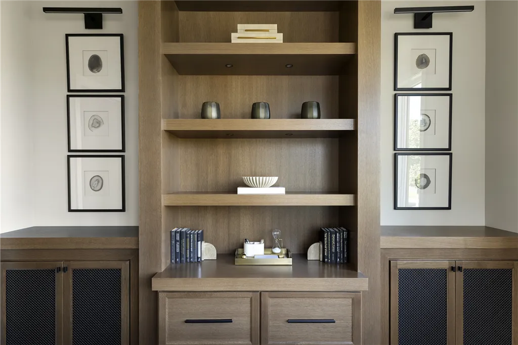 Contemporary minimalist interior with wooden furniture including a shelf, drawer, and cabinet.
