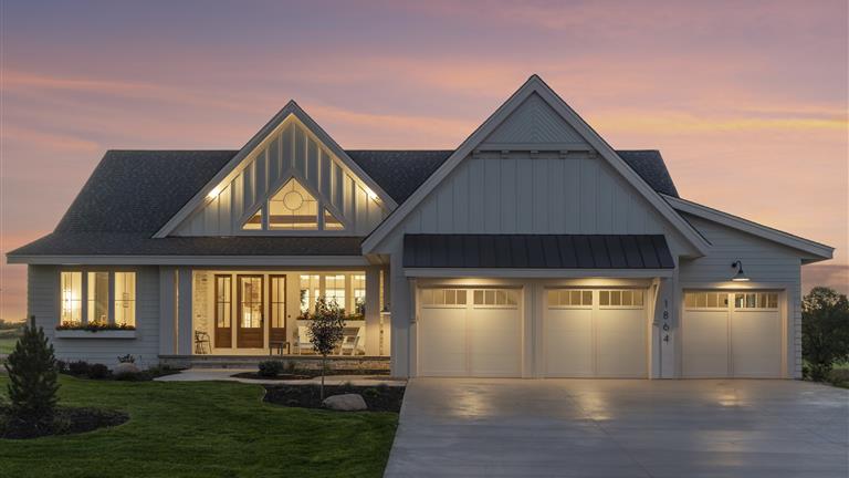 Exterior view of a luxury suburban home with a spacious driveway.