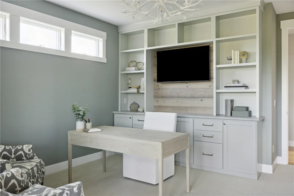 Spacious contemporary home office with modern furniture and large windows.