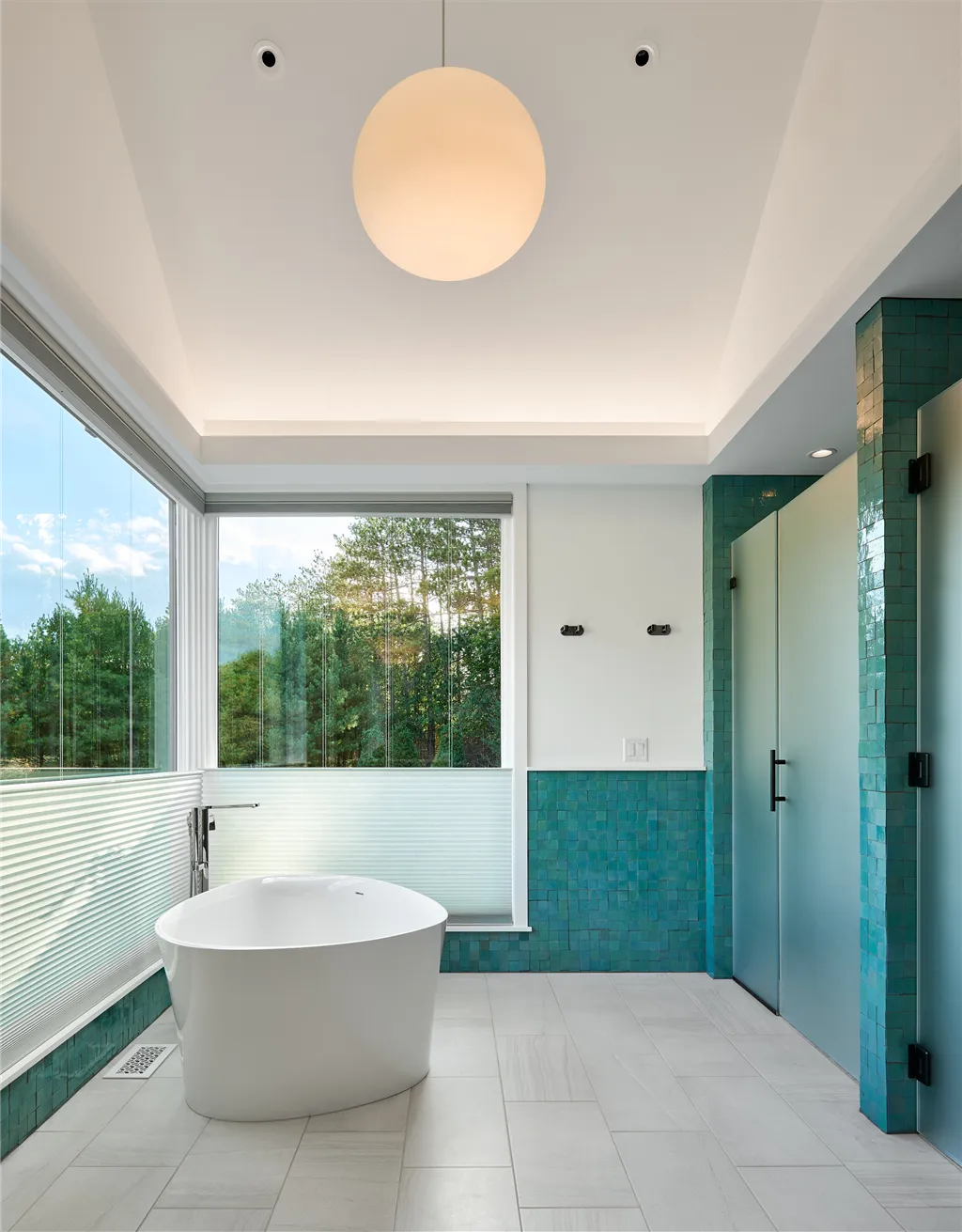 Contemporary luxury bathroom with minimalist design and large bathtub.