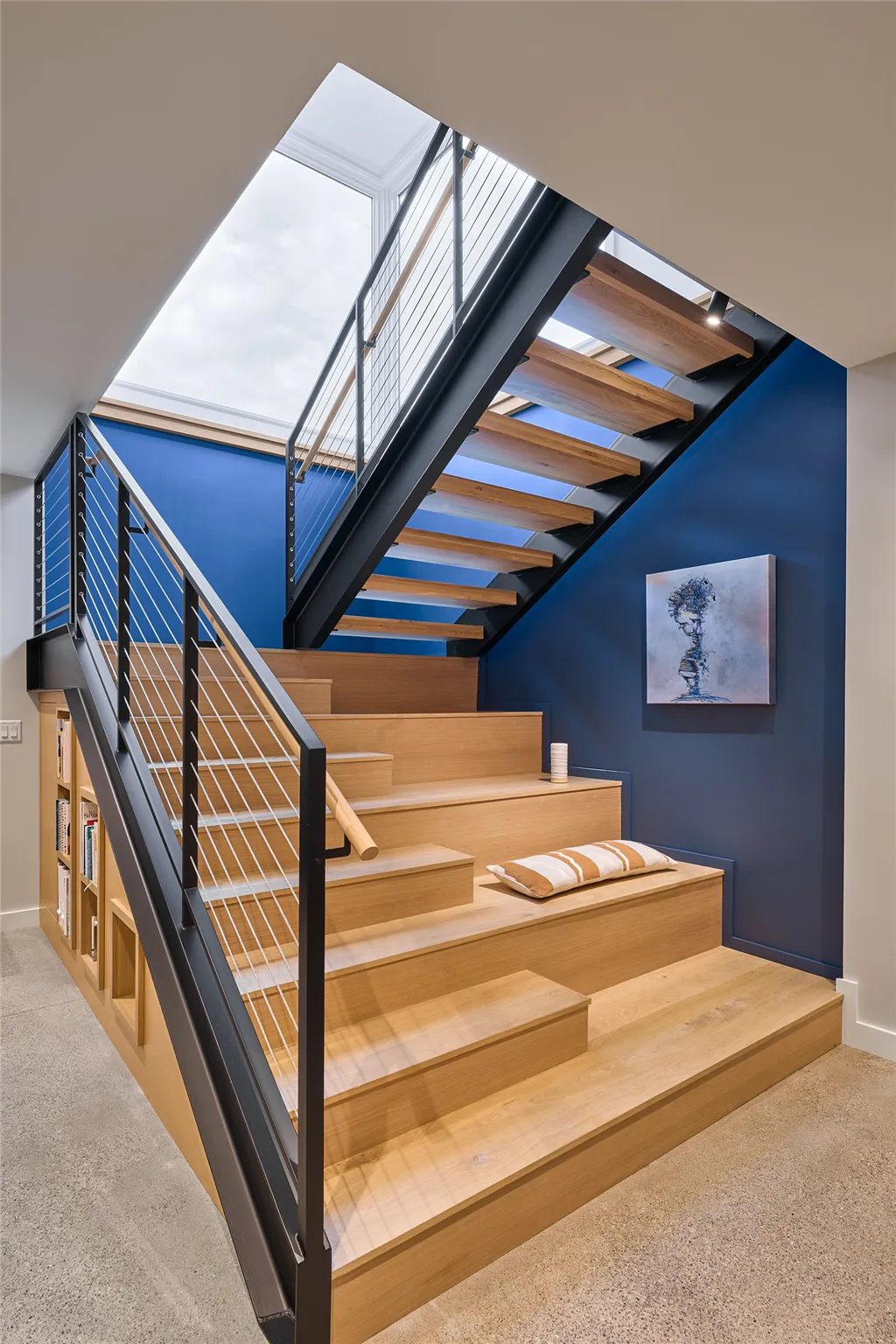 Modern minimalist basement stairway with wooden parquet and sleek handrail.