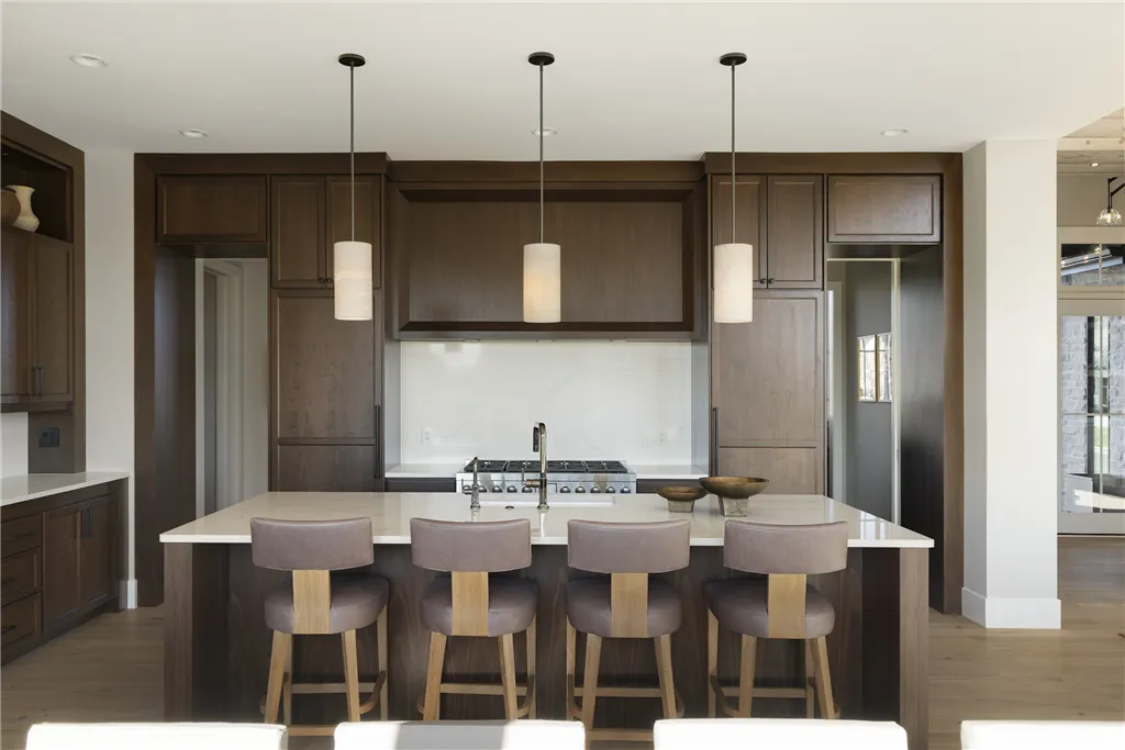 Contemporary minimalist dining room with luxurious furniture and large windows.