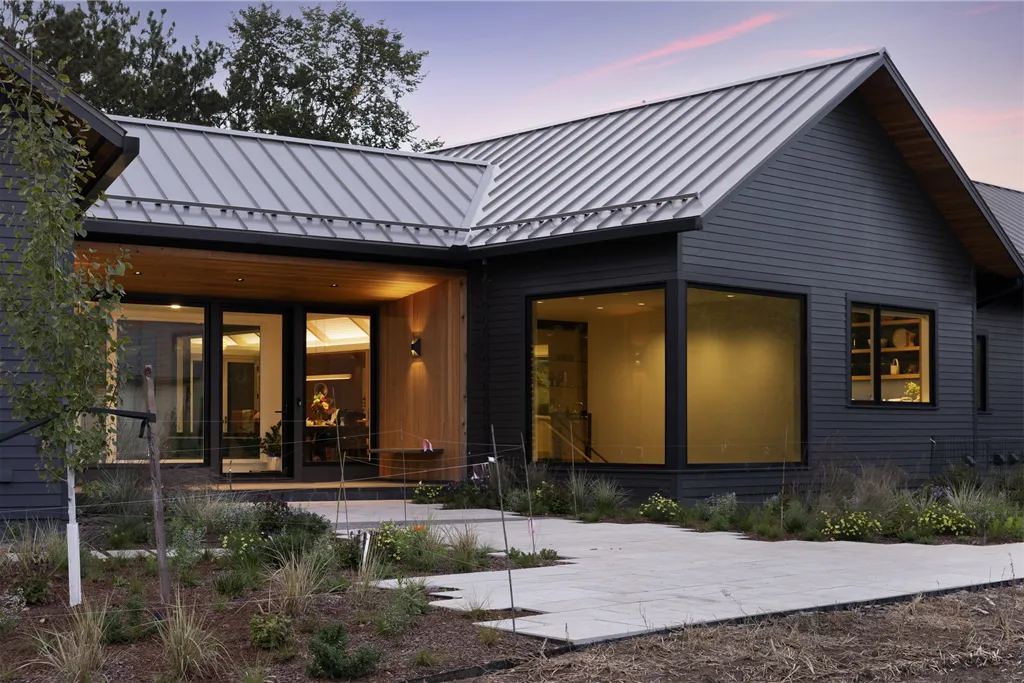 Exterior view of an elegant suburban home with a driveway and porch.