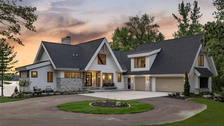 Luxury suburban home in Stillwater, MN at twilight with a spacious driveway and well-maintained lawn.