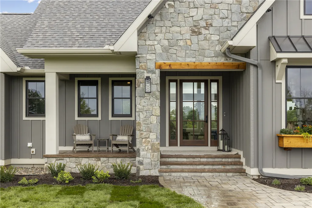 Luxury suburban home with a grand entrance and porch.