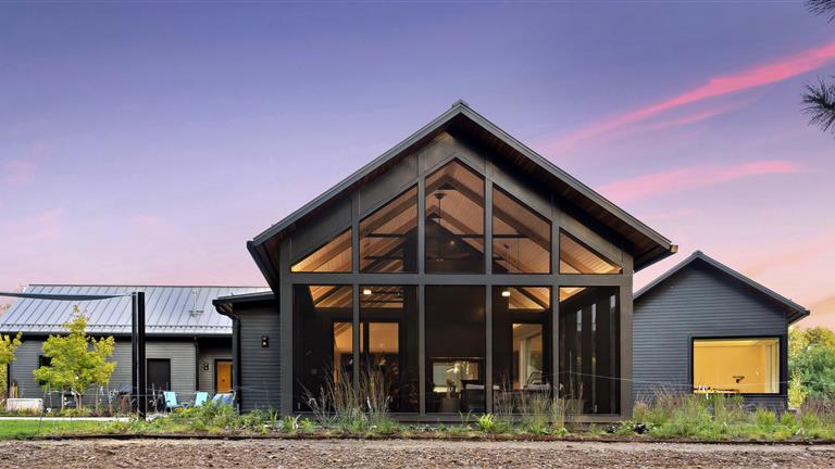 Exterior view of a modern luxury home with garage and windows.
