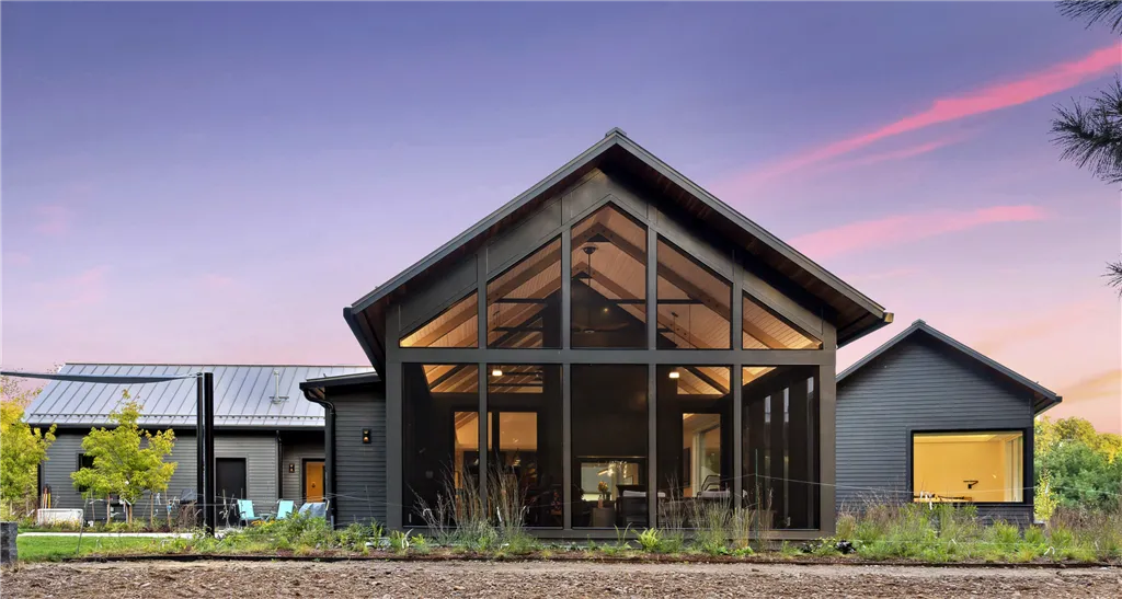 Exterior view of a modern luxury home with garage and windows.