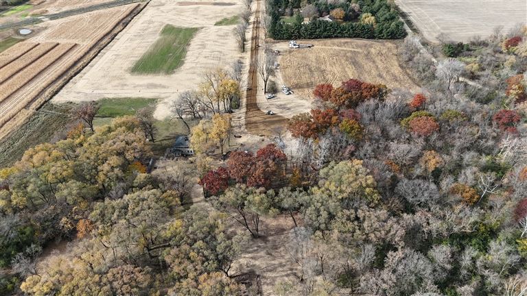 Aerial view of Oaks of St. Croix with trees, mountains, and a house.