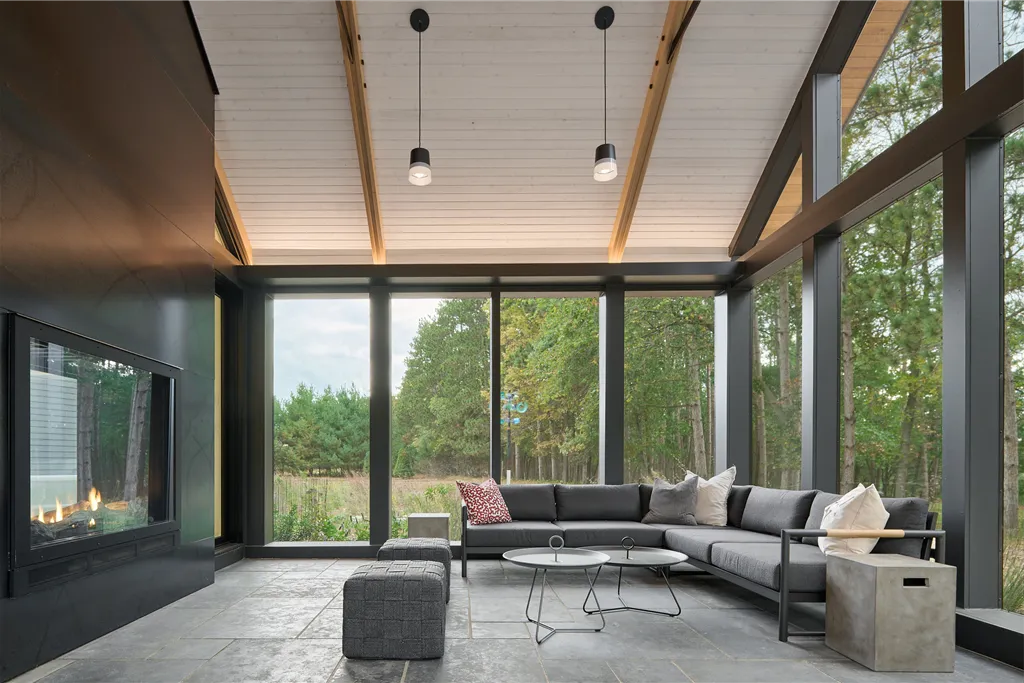 Luxurious contemporary family room with large windows and minimalist furniture.