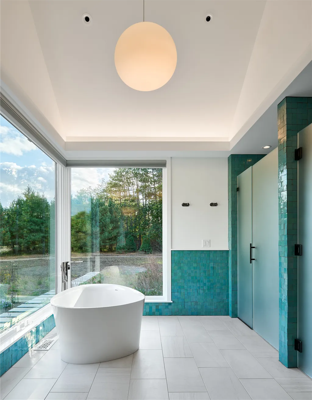 Contemporary luxury bathroom with minimalist design and large bathtub.