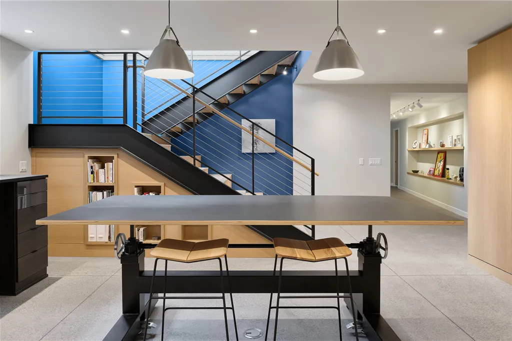 Spacious contemporary luxury basement interior with modern furniture and large windows.