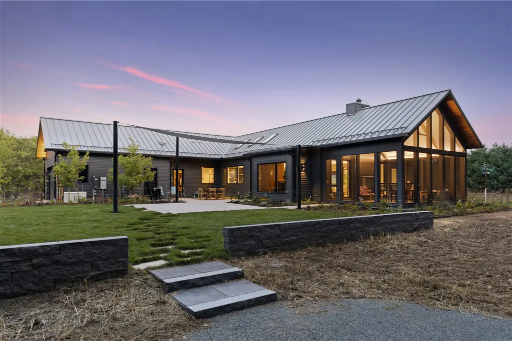 Exterior view of a luxury suburban home with a garage and yard.