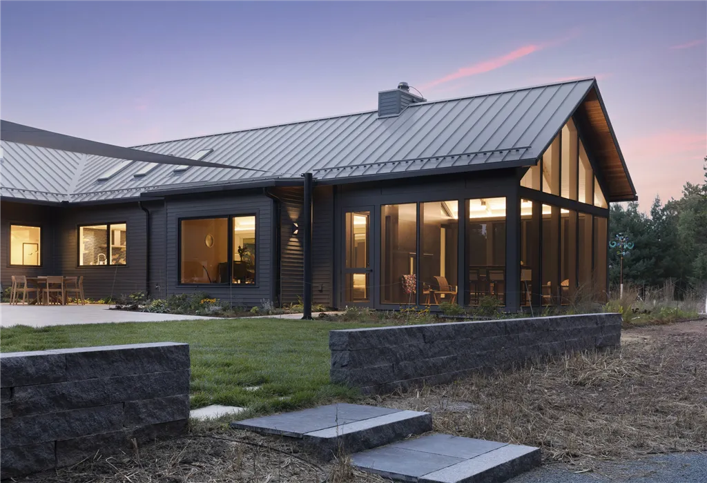 Exterior view of a luxury suburban home with a driveway and garage.