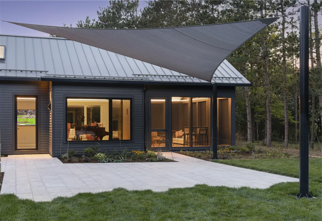 Exterior view of a luxury suburban home with a spacious driveway and well-maintained lawn.