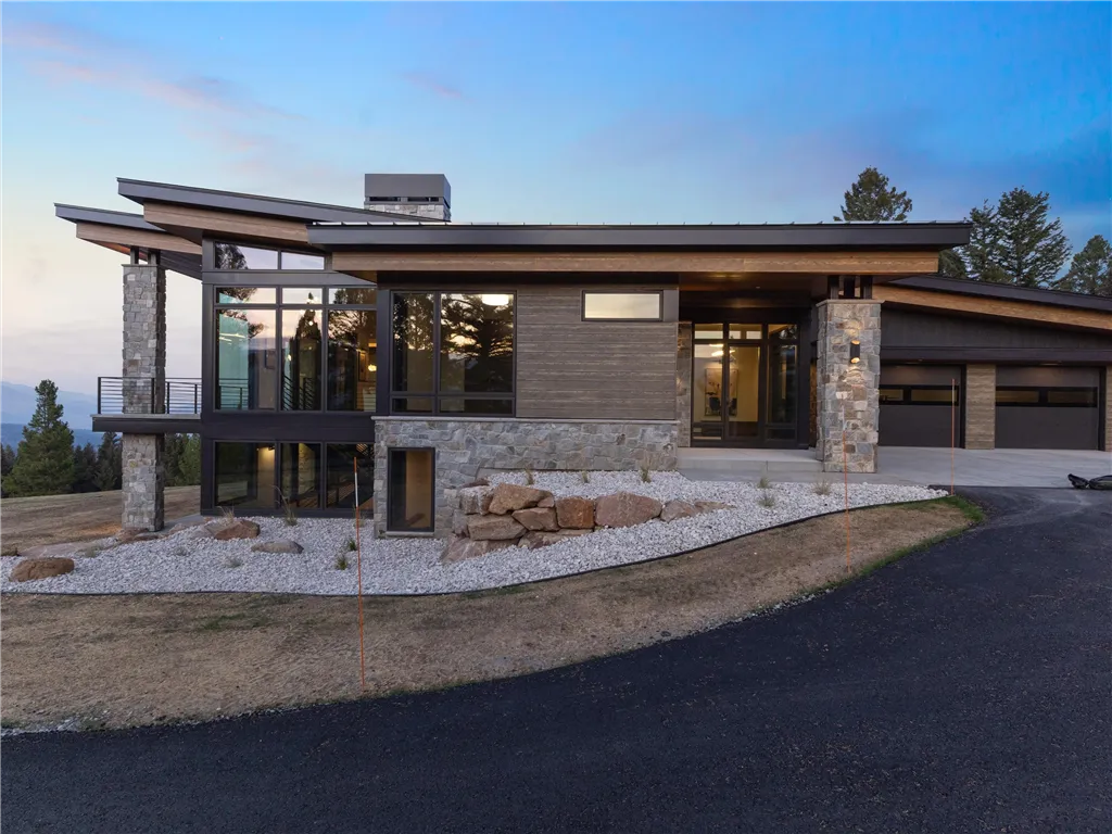 Suburban brick house with a garage and driveway in a quiet neighborhood.