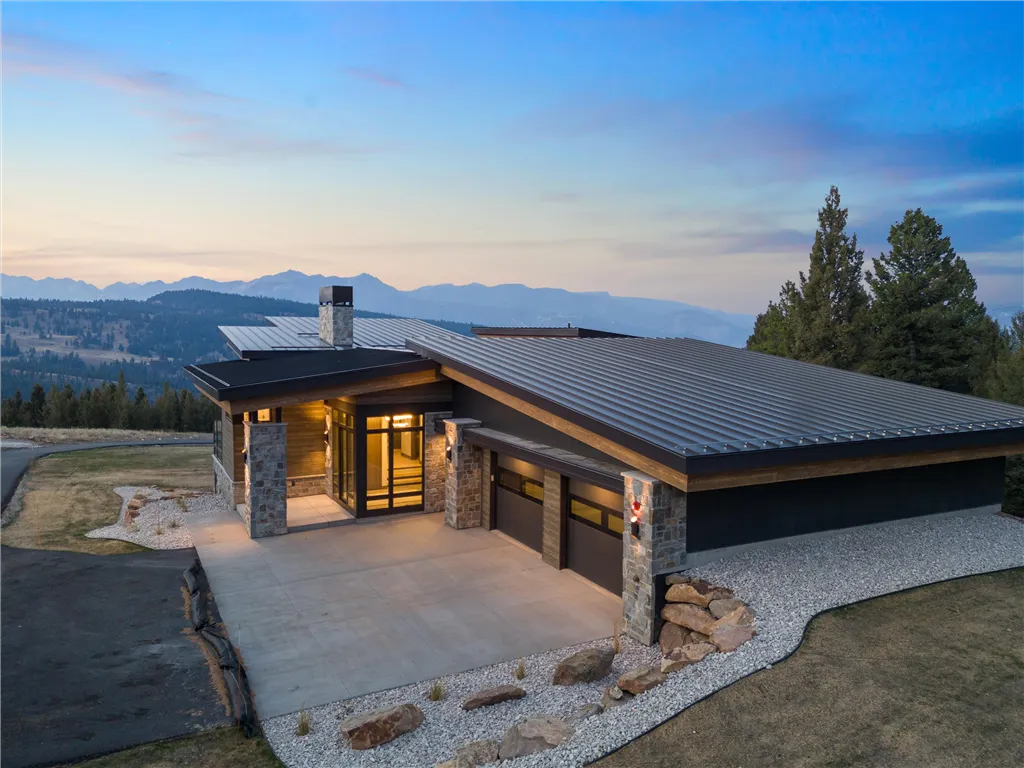 Wooden cabin at sunset with a scenic landscape.